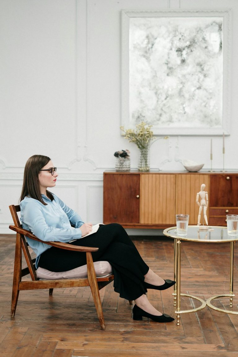 Therapist talks to a client in a well-designed office.